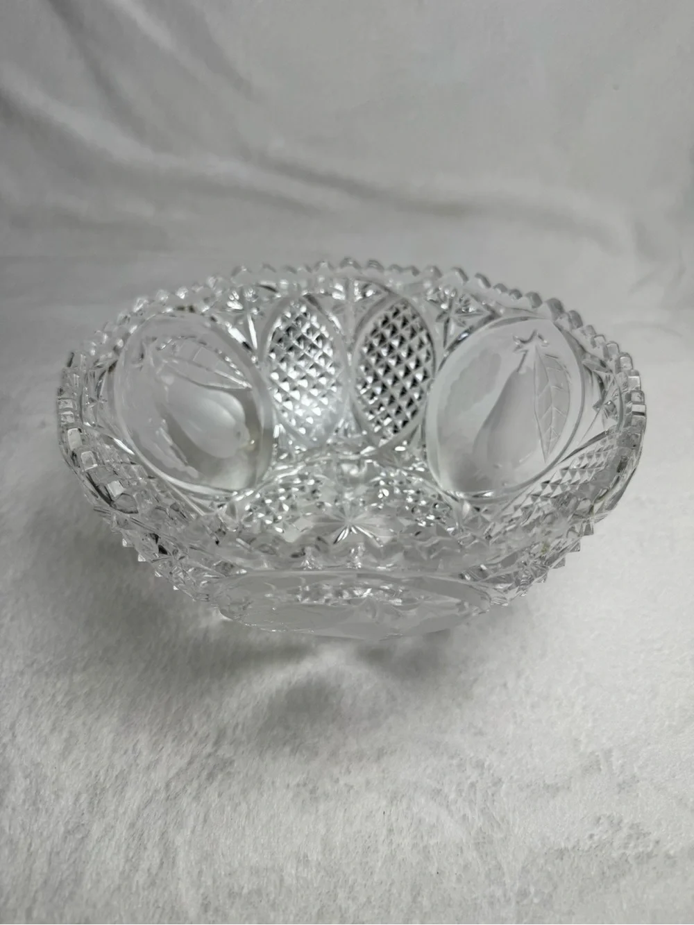 This vintage crystal cut and pressed pear and grape etched footed bowl 8.5”